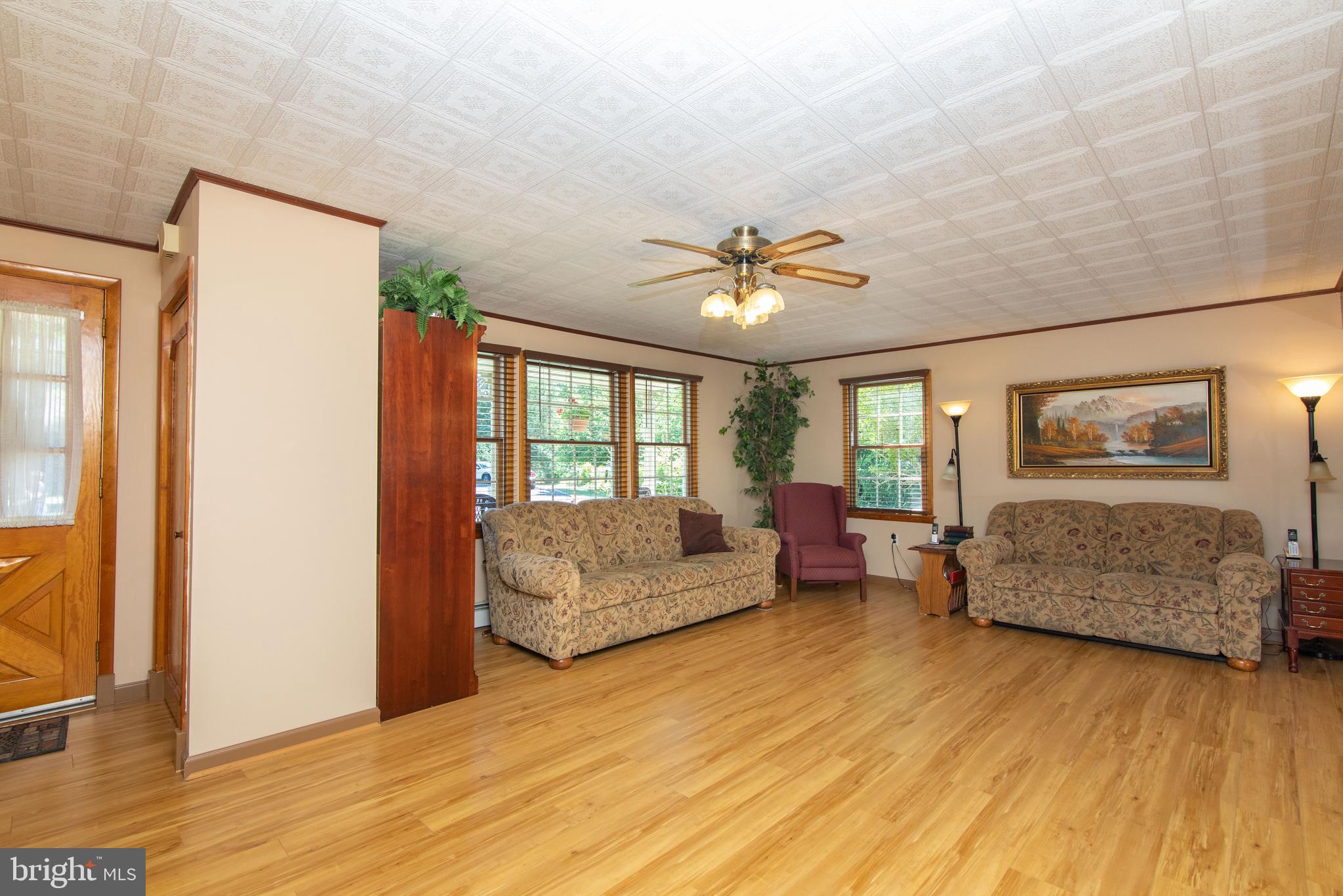 741 Heritage Road Sewell, NJ 08080 - Photo 12 of 60 a living room with furniture and a large window