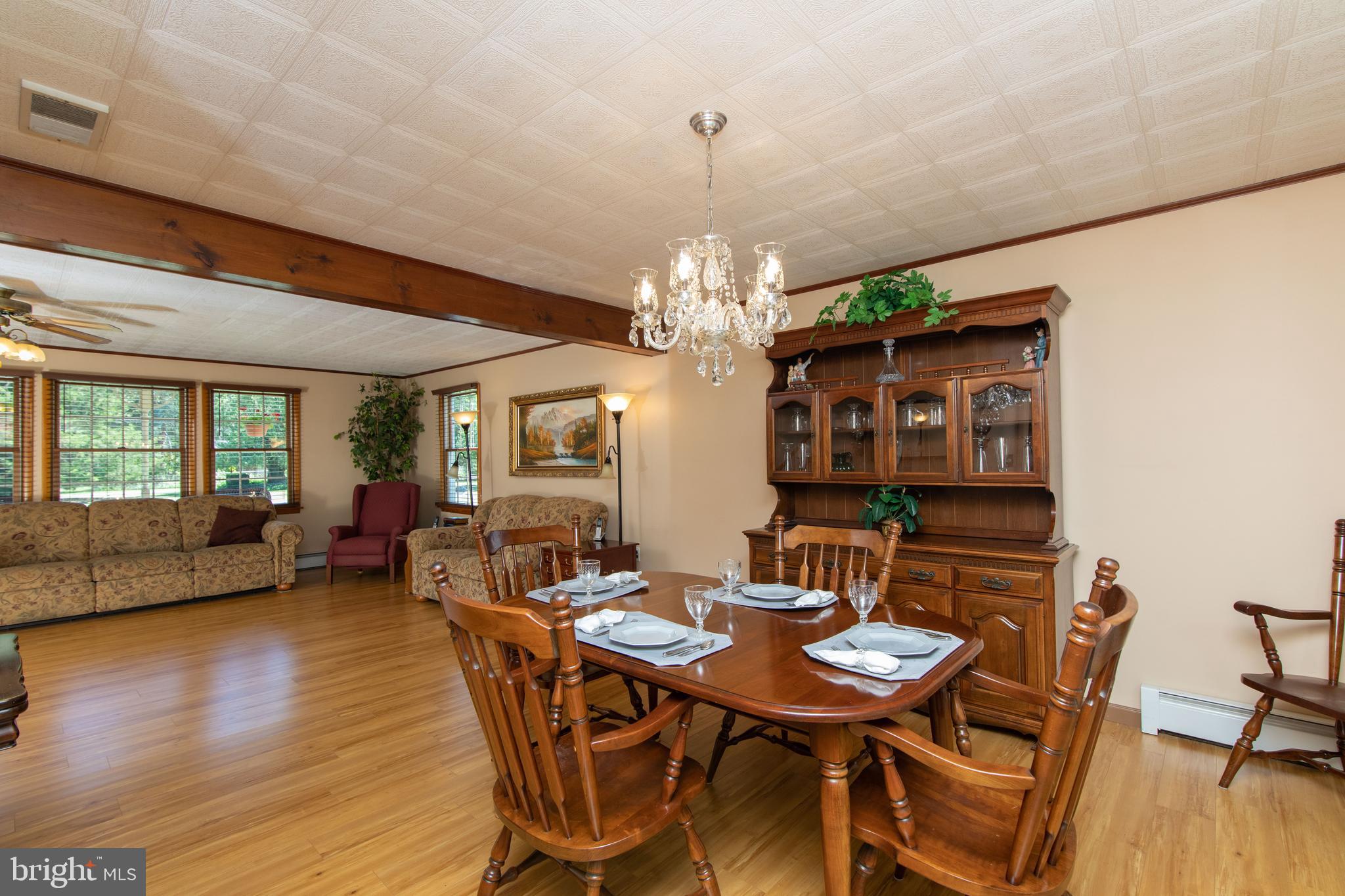 741 Heritage Road Sewell, NJ 08080 - Photo 18 of 60 a view of a dining room with furniture window and wooden floor