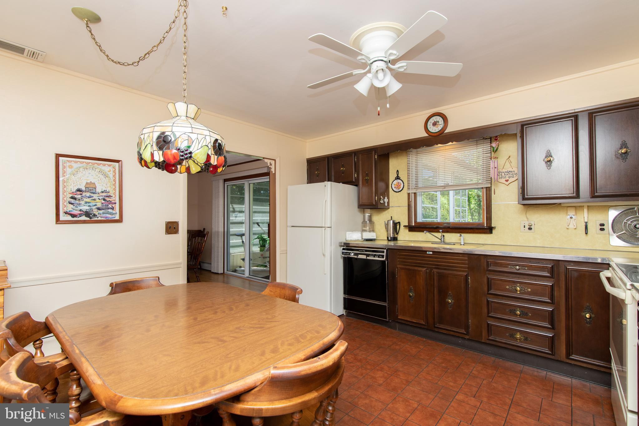 741 Heritage Road Sewell, NJ 08080 - Photo 21 of 60 a kitchen with stainless steel appliances granite countertop a sink a stove a refrigerator a dining table and chairs with wooden floor