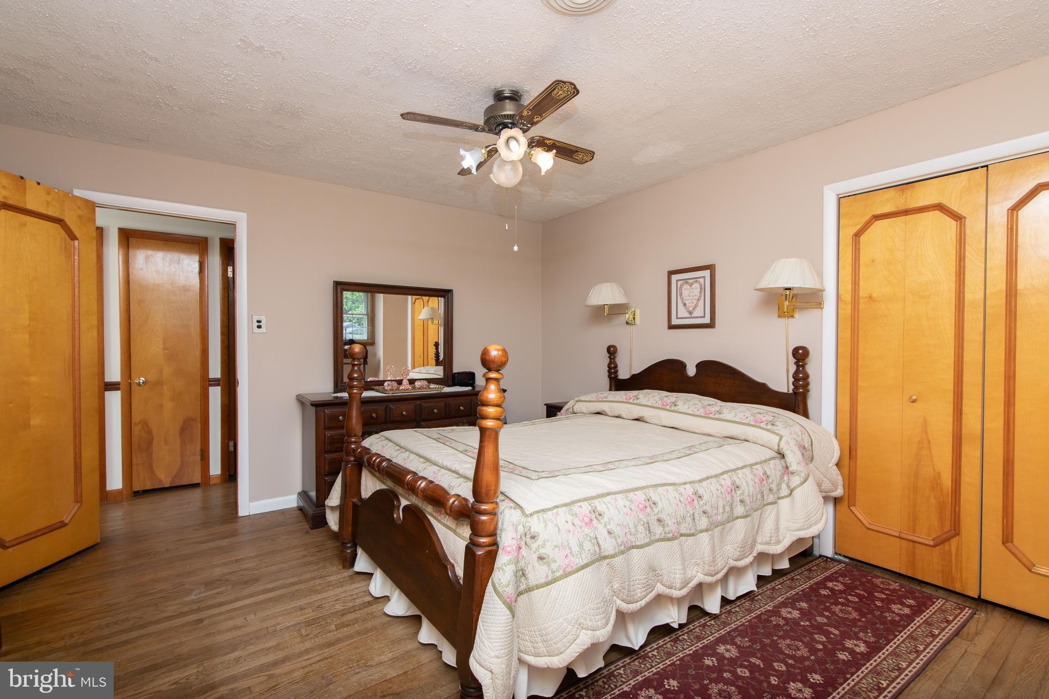741 Heritage Road Sewell, NJ 08080 - Photo 32 of 60 a bedroom with a bed and a chandelier