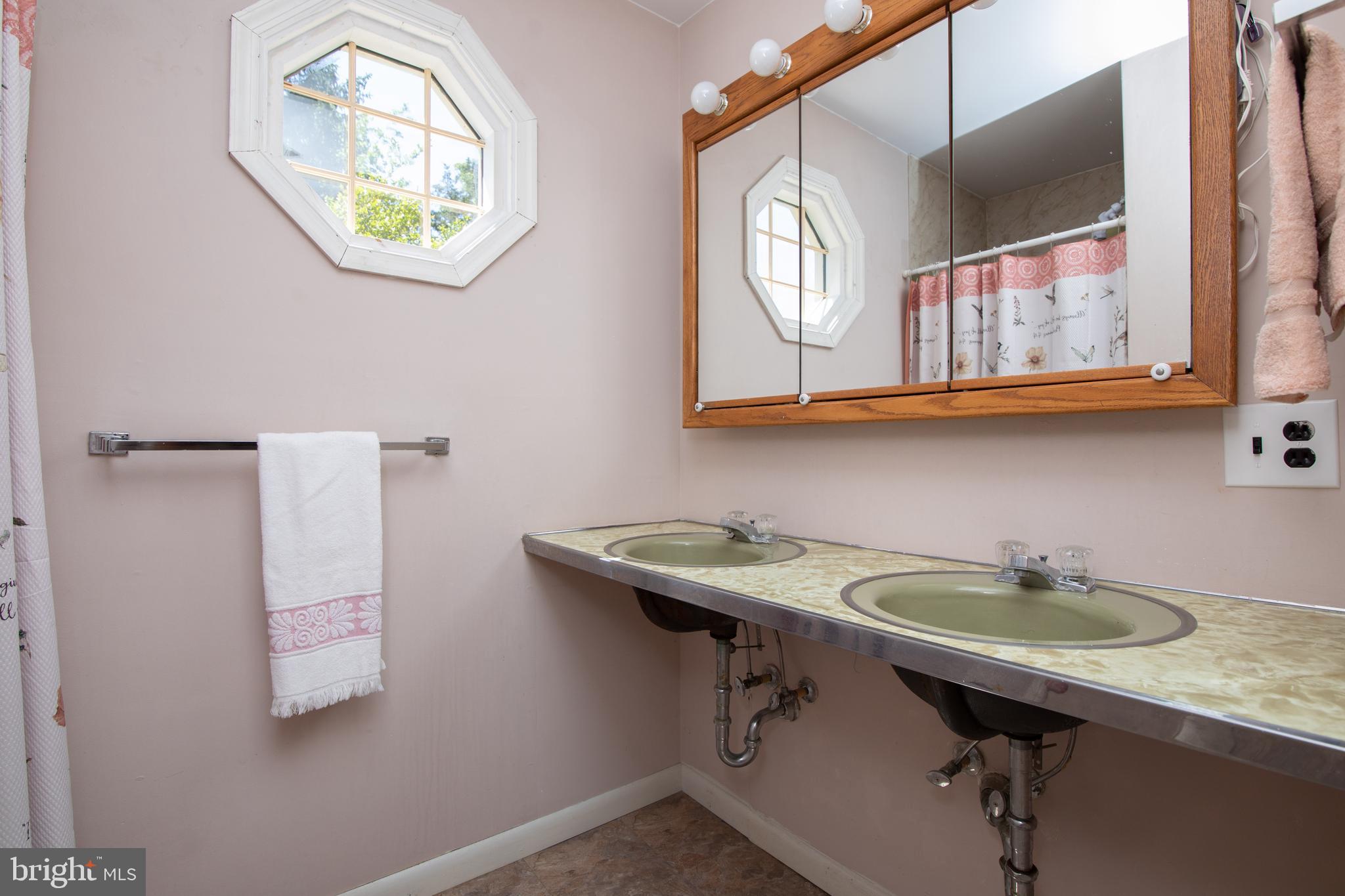 741 Heritage Road Sewell, NJ 08080 - Photo 36 of 60 a bathroom with a sink a mirror and a window