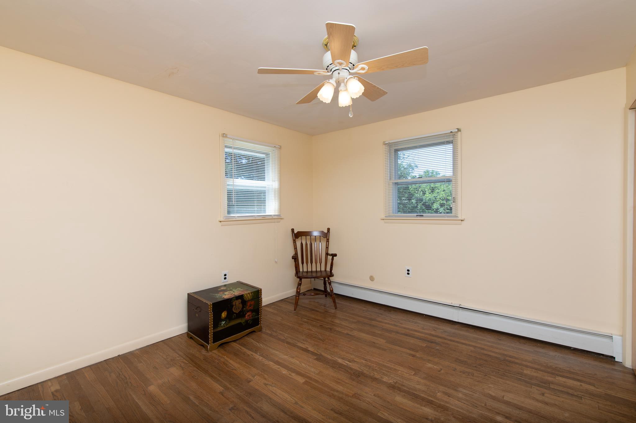 741 Heritage Road Sewell, NJ 08080 - Photo 37 of 60 an empty room with wooden floor and ceiling fan