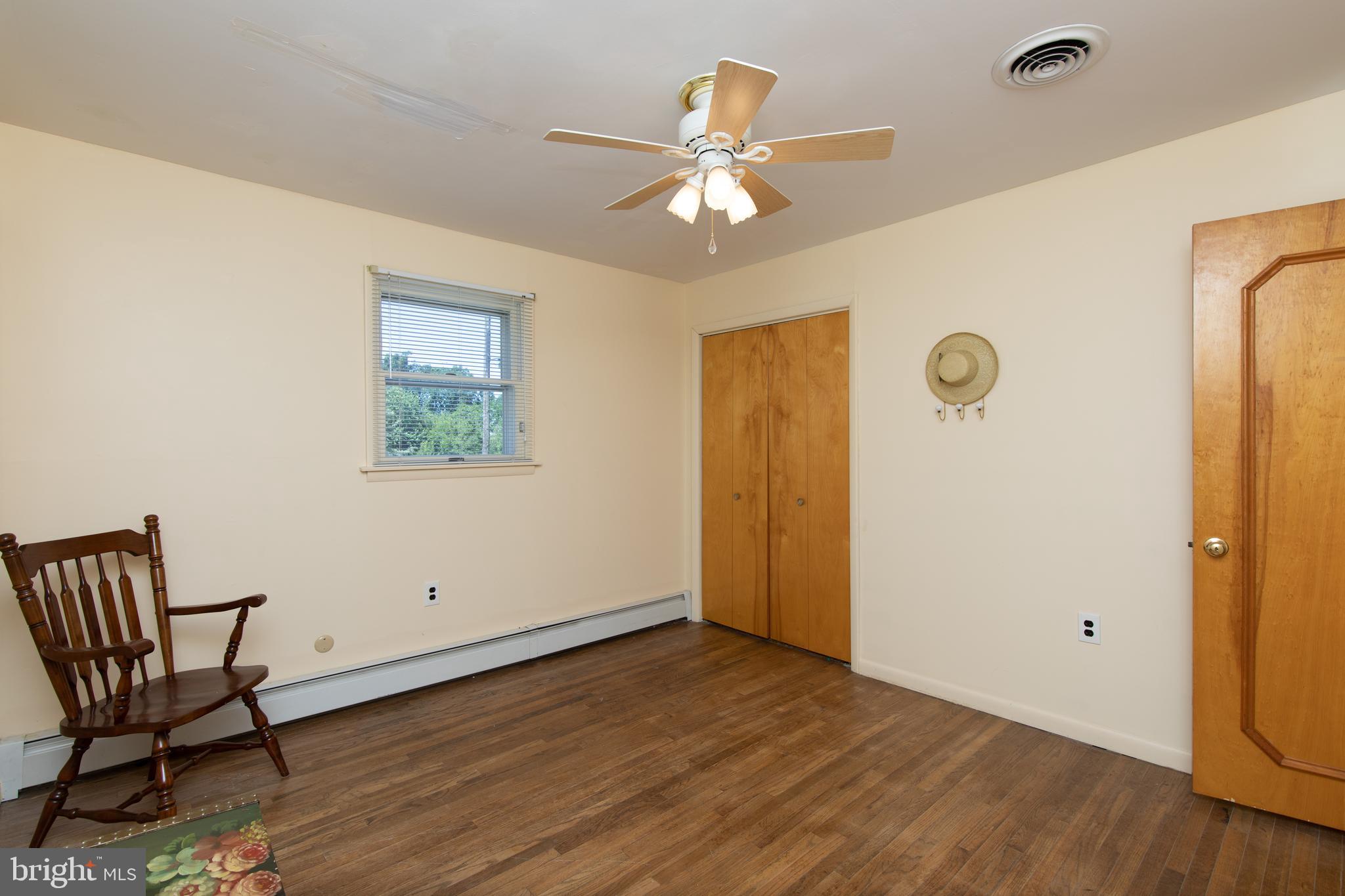 741 Heritage Road Sewell, NJ 08080 - Photo 39 of 60 a view of an empty room with wooden floor and a ceiling fan