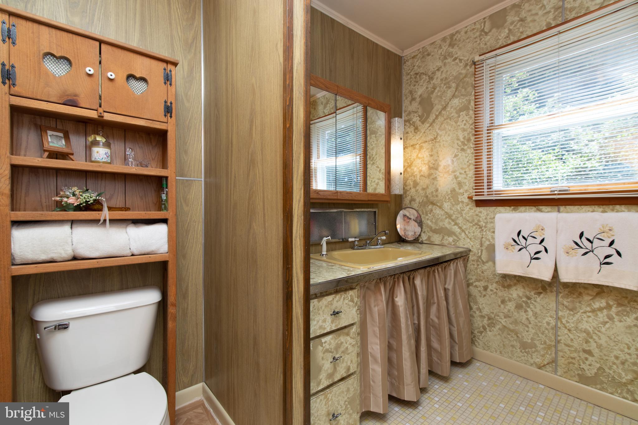 741 Heritage Road Sewell, NJ 08080 - Photo 43 of 60 a bathroom with a granite countertop sink a toilet and a window