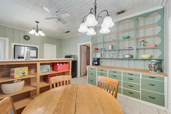 a view of a dining room with furniture and a chandelier