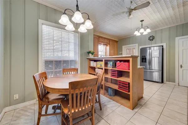 a dining room with furniture and a chandelier