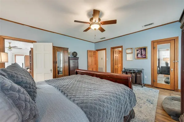 a bedroom with a large bed and a large window