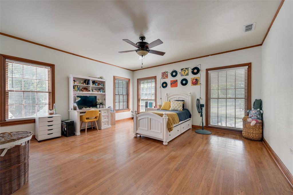 233 East High Street Wills Point, TX 75169 - Photo 20 of 40 Bedroom with a desk, crown molding, light wood-style flooring, and ceiling fan