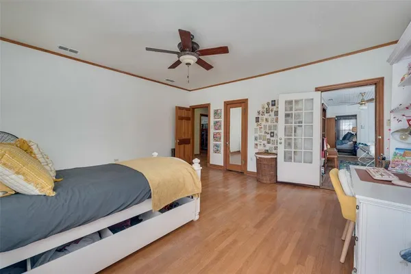 a bed room with a bed window and a chandelier
