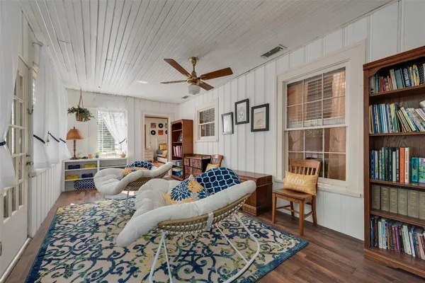 a living room with furniture and a book shelf
