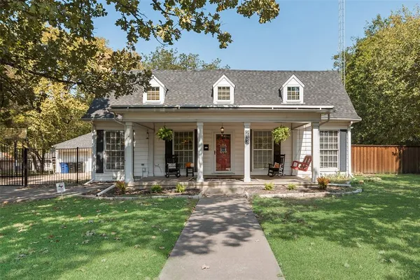 a front view of a house with sitting area and garden