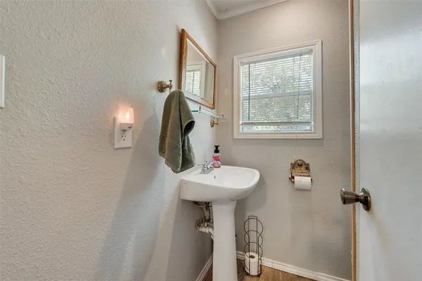 a bathroom with a sink a mirror and a window