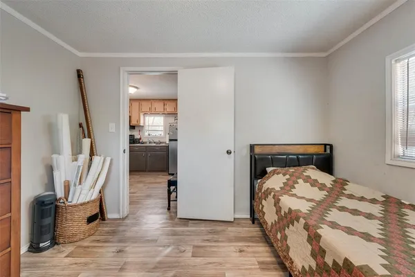 a bedroom with a bed and a large mirror