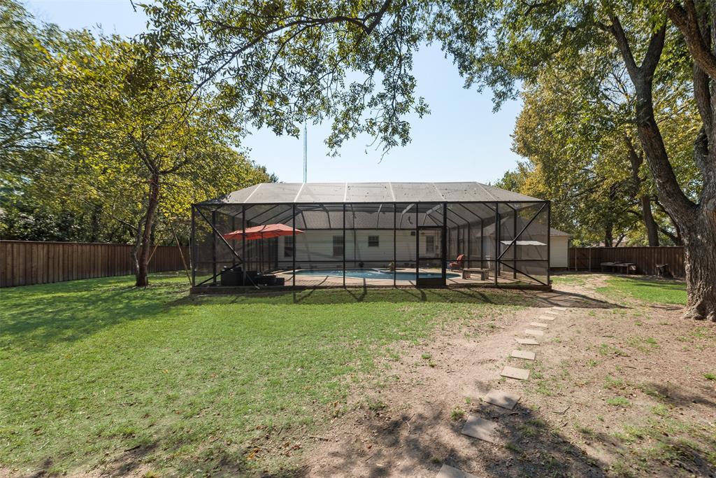 233 East High Street Wills Point, TX 75169 - Photo 36 of 40 Back of house with a lanai, an outdoor pool, a fenced backyard, a sunroom, and a patio