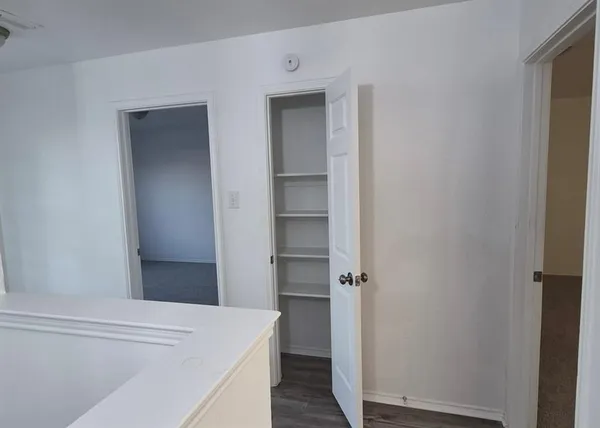 a view of hallway with wooden floor