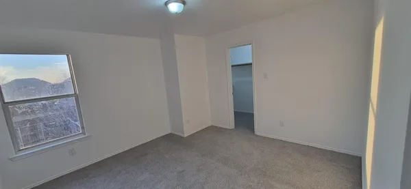 a view of an empty room with a window
