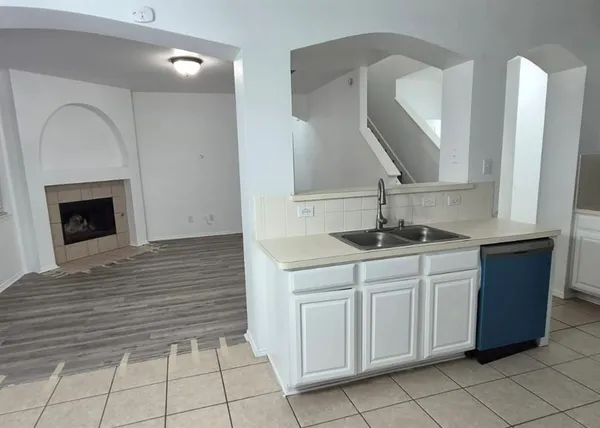 a kitchen with a sink and a mirror