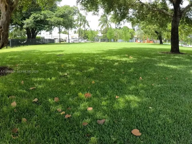 a view of grassy field with benches