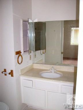 560 Spring Road, Unit 81 Moorpark, CA 93021 - Photo 11 of 14 a bathroom with a granite countertop sink and a mirror