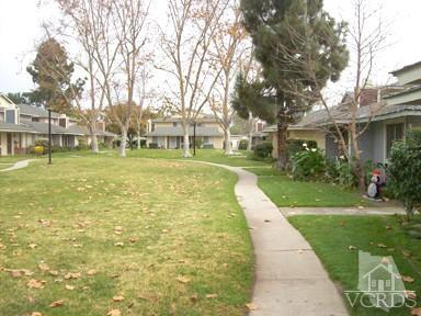 560 Spring Road, Unit 81 Moorpark, CA 93021 - Photo 3 of 14 a view of yard with swimming pool and green space