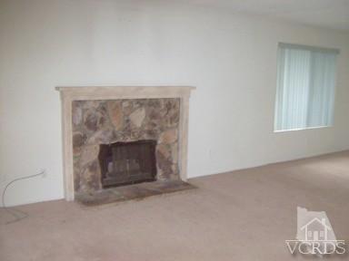 560 Spring Road, Unit 81 Moorpark, CA 93021 - Photo 5 of 14 an empty room with a fireplace