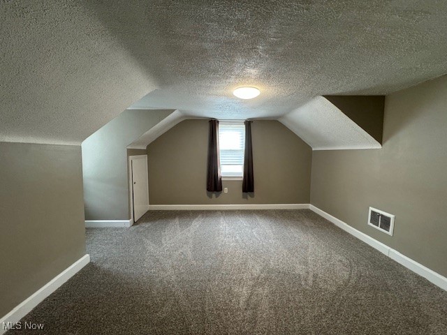 520 8th Street Struthers, OH 44471 - Photo 13 of 22 Bonus room with a textured ceiling, carpet, and vaulted ceiling