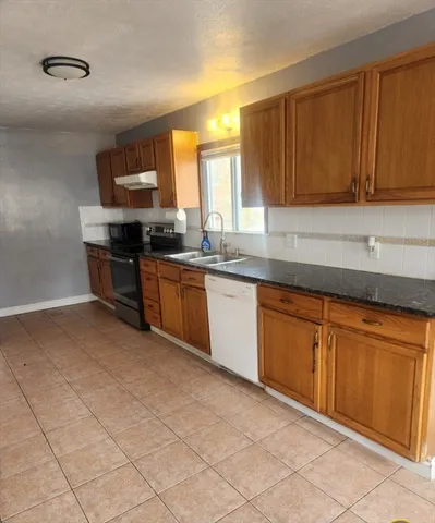 a kitchen with stainless steel appliances granite countertop a sink and cabinets