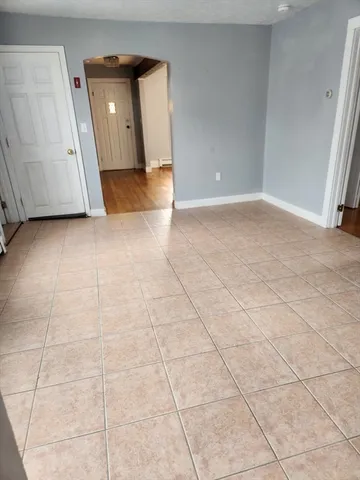 a view of a livingroom with wooden floor and a cabinet