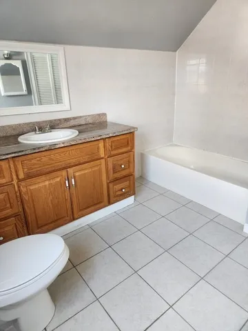 a bathroom with a sink a toilet and bathtub