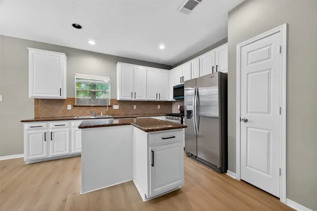 a large kitchen with stainless steel appliances lots of counter top space