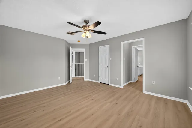 a view of an empty room and wooden floor