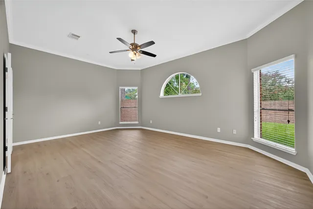 a bedroom with furniture and a large window