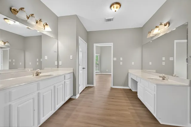 a view of a kitchen with wooden floor and a sink