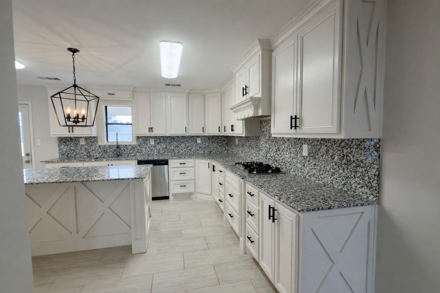 611 South Avenue H Post, TX 79356 - Photo 11 of 32 a kitchen with stainless steel appliances granite countertop a sink stove and cabinets