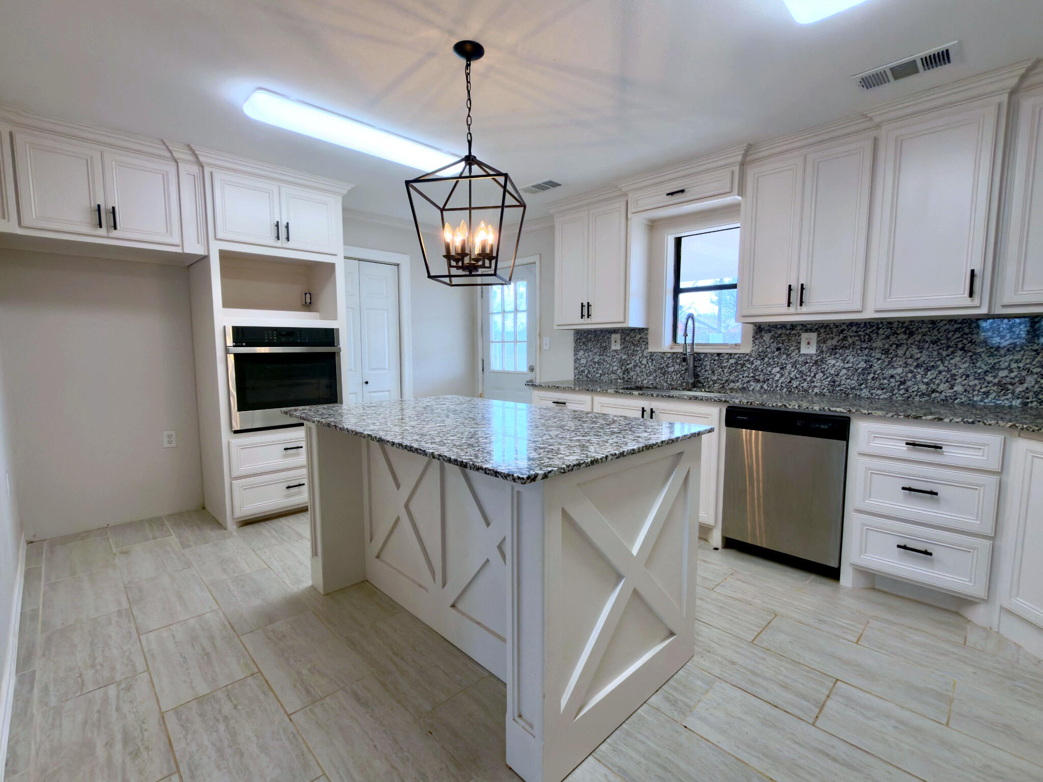 611 South Avenue H Post, TX 79356 - Photo 12 of 32 a kitchen with stainless steel appliances granite countertop a sink stove a refrigerator and a granite counter tops with wooden floors