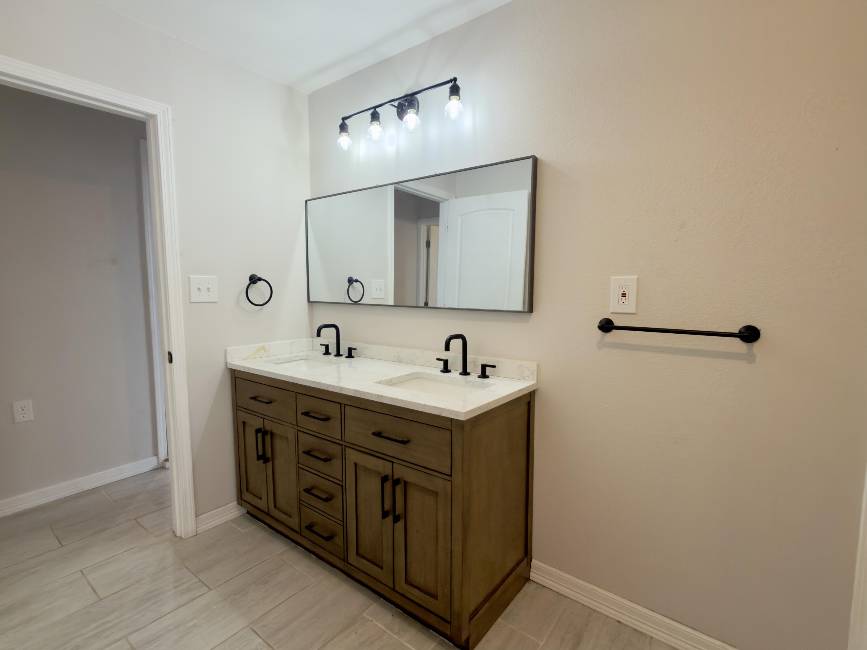 611 South Avenue H Post, TX 79356 - Photo 26 of 32 a bathroom with a sink and a mirror