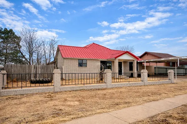 a front view of a house with a fence