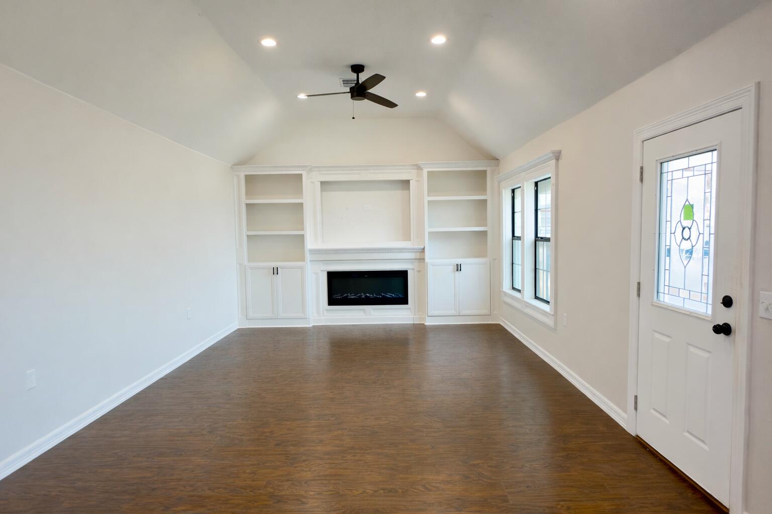 611 South Avenue H Post, TX 79356 - Photo 5 of 32 a view of an empty room with a fireplace and a window