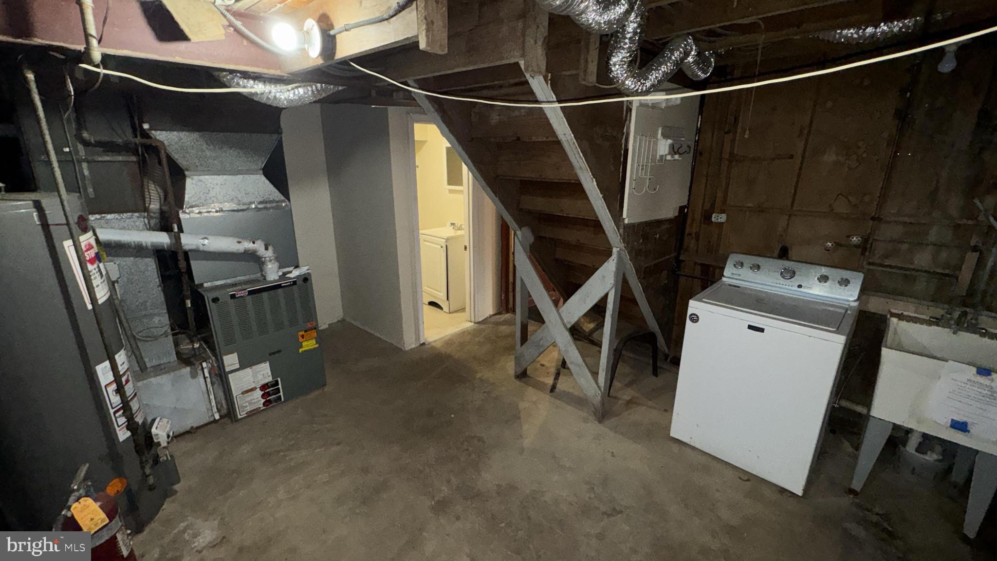6502 Knollbrook Drive Hyattsville, MD 20783 - Photo 18 of 21 a view of a storage room with washer and dryer
