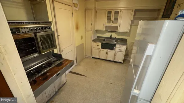 a kitchen with a stove and a refrigerator