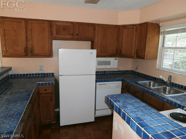 7615 Carrier Road Fort Myers, FL 33967 - Photo 3 of 8 a kitchen with a refrigerator and a sink