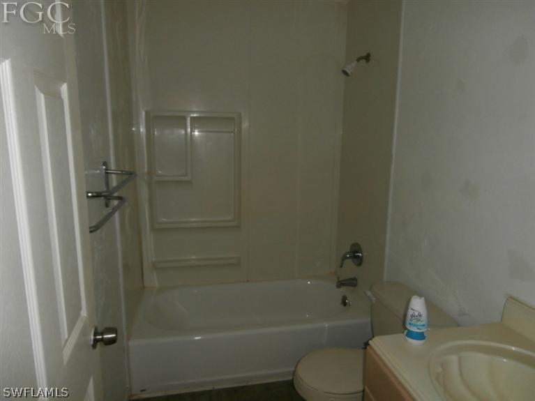 7615 Carrier Road Fort Myers, FL 33967 - Photo 5 of 8 a bathroom with a sink toilet and shower