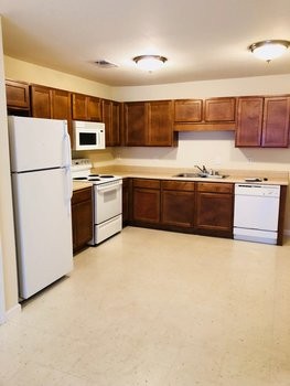 9063 Pembroke Road, Unit B Oak Grove, TN 42262 - Photo 6 of 12 a large kitchen with stainless steel appliances granite countertop a refrigerator stove a sink dishwasher and wooden cabinets