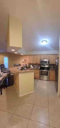 a kitchen with stainless steel appliances granite countertop a sink and cabinets