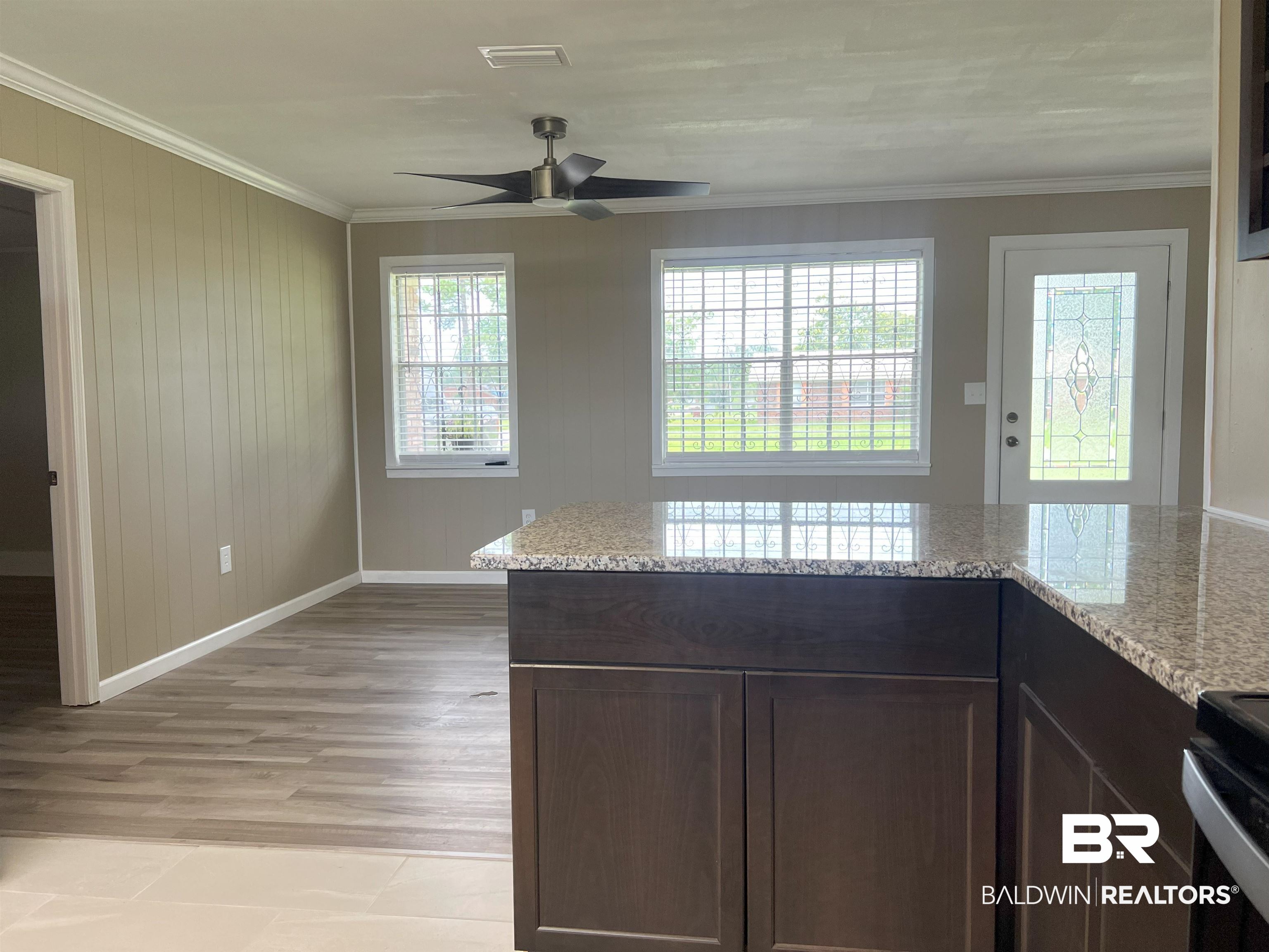 508 Freemanville Drive Atmore, AL 36502 - Photo 9 of 27 Kitchen with dark brown cabinetry, ceiling fan, light stone counters, and light hardwood / wood-style flooring