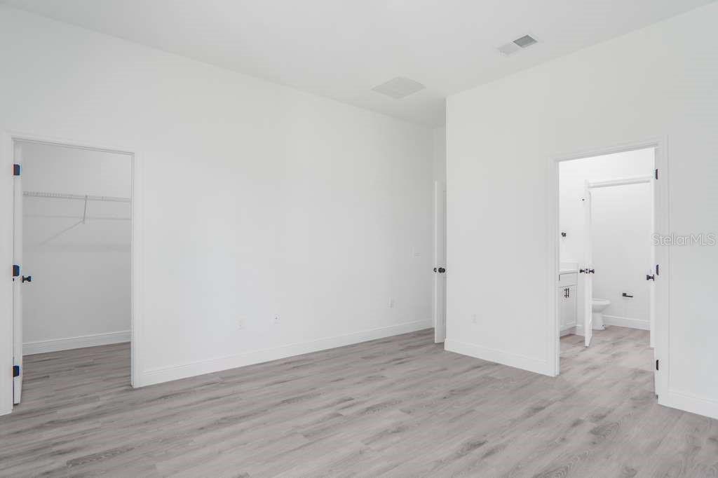 15683 Southwest 49th Avenue Road Ocala, FL 34473 - Photo 15 of 27 a view of an empty room with wooden floor