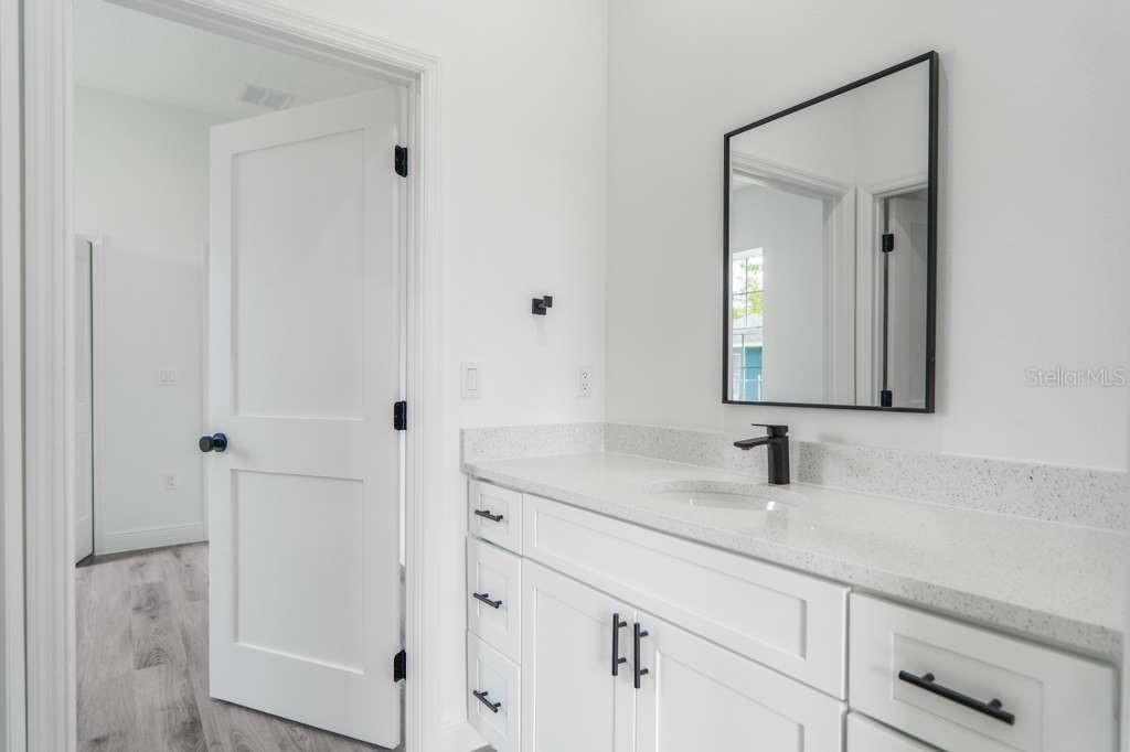 15683 Southwest 49th Avenue Road Ocala, FL 34473 - Photo 19 of 27 a bathroom with a sink and a mirror