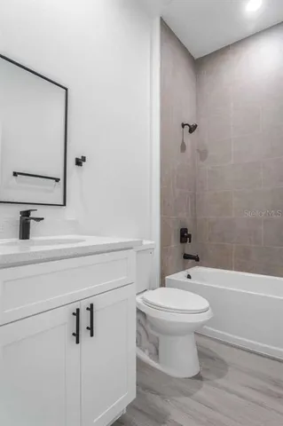 a bathroom with a toilet a sink and bathtub