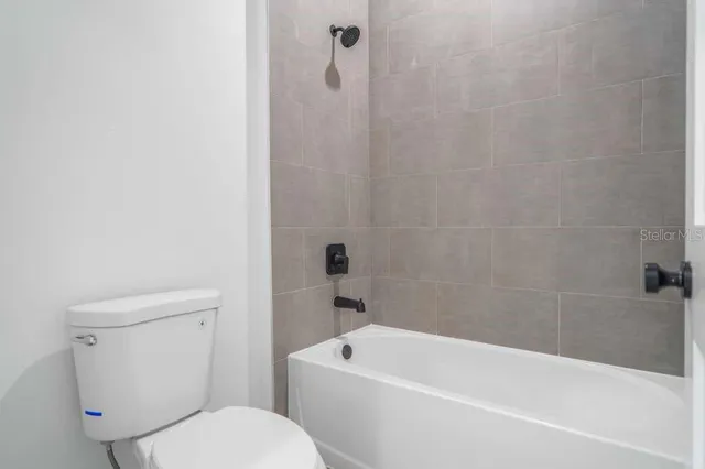 a bathroom with a toilet and bathtub