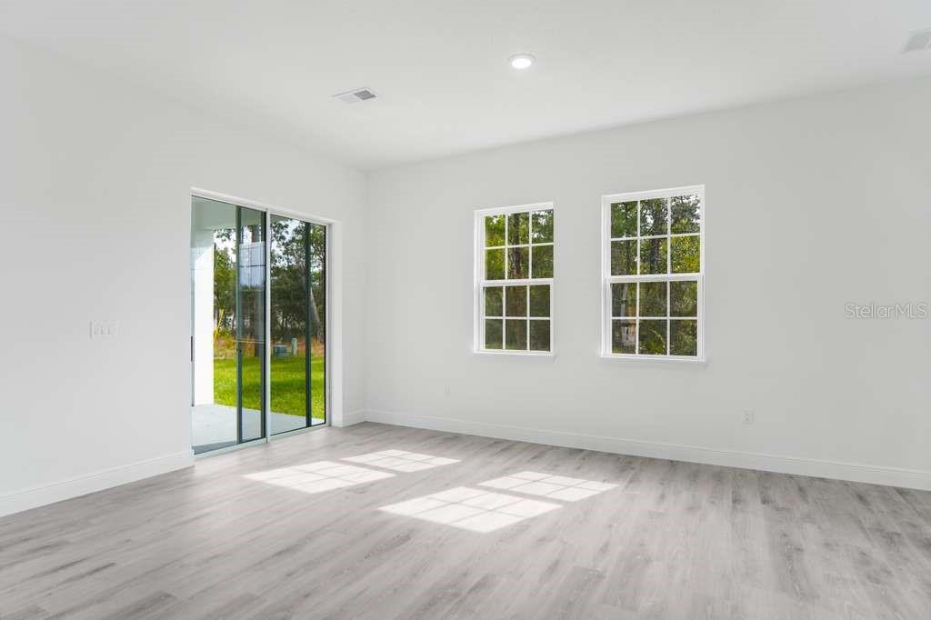 15683 Southwest 49th Avenue Road Ocala, FL 34473 - Photo 3 of 27 an empty room with windows